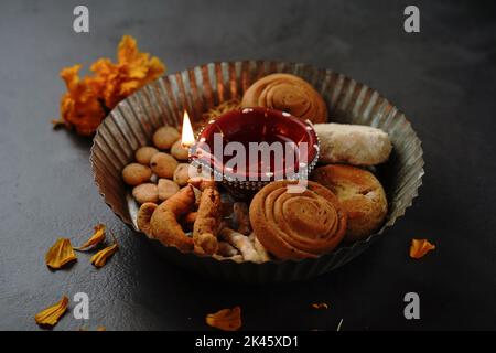 Diwali snack con lampada Diya accesa - Deepavali sfondo, focu selettivo Foto Stock