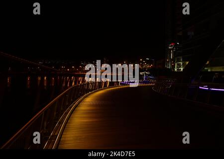 Un bellissimo paesaggio urbano notturno con una passerella poco illuminata sul ponte di Elizabeth Quay, Perth Foto Stock