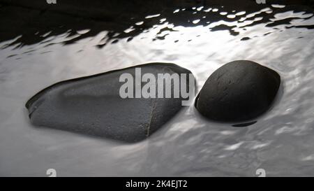 Rocce grigio scuro in una piscina su una spiaggia. Astratto sfondo natura. Foto Stock