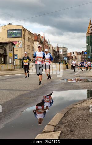 Slesia Marathon 2022, Katowice, Slesia, Polonia. Ottobre 02, 2022. Slesia Marathon 2022. maratona gambe e riflesso in una pozza sulla strada Foto Stock