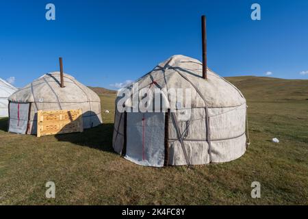 Campo turistico panoramico di yurt nomade sulle pianure del lago di Song Kul, Kirghizistan Foto Stock