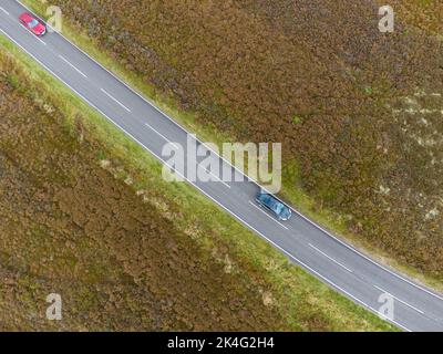 Viaggiare su una remota strada di brughiera nel Regno Unito Foto Stock