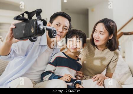 Una famiglia asiatica felice indossa la realtà virtuale per giocare Foto Stock