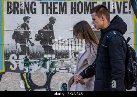 Kiev, Ucraina. 24th Set, 2022. La gente passa davanti a un poster con l'iscrizione "portali a casa vivi" nel centro di Kyiv. Ogni giorno muoiono in media 50 soldati ucraini in battaglia con l'esercito russo. Credit: SOPA Images Limited/Alamy Live News Foto Stock