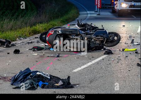 03 ottobre 2022, Baviera, Geiselhöring: Una moto completamente distrutta si trova su una strada. In un incidente tra un'auto e un gruppo di motociclisti, uno dei ciclisti è morto. Un secondo motociclista è stato preso in ospedale gravemente ferito. Foto: Armin Weigel/dpa - ATTENZIONE: Le targhe sono state pixelate per motivi legali Foto Stock