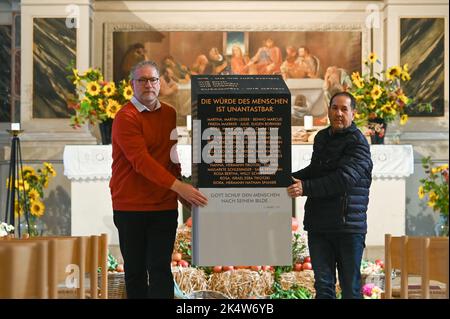 04 ottobre 2022, Sassonia-Anhalt, Zerbst: Il pastore Lutz-Michael Sylvester (l) e Mario Gabler, presidente del consiglio parrocchiale, portano il modello attraverso la chiesa di San Trinitatis. A Zerbst, il modello della stele contro-memoriale 'riflessioni' sul rilievo invettivo del 'Judensau' è stato presentato sul lato nord della chiesa Zerbst di San Nicolai. Il contro-memoriale è da erigere nelle immediate vicinanze della scultura anti-ebraica, il 'Judensau', che è stato su un pilastro delle attuali rovine della chiesa di San Nicolai dall'anno 1450, secondo un spo Foto Stock