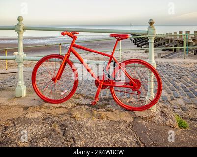 Bicicletta rossa brillante a Portobello Promenade, Edimburgo, Scozia, Regno Unito Foto Stock