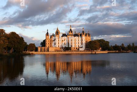 Schwerin, Germania. 03rd Ott 2022. Il castello di Schwerin si illumina di giallo dorato al sole della sera. Credit: Bernd Wüstneck/dpa/Alamy Live News Foto Stock