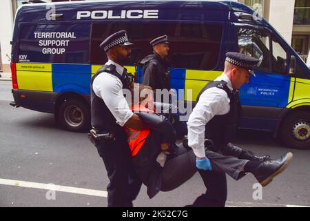 Londra, Regno Unito. 5th ottobre 2022. Arresto della polizia basta fermare i manifestanti di petrolio che bloccano Horseferry Road. Alcuni attivisti hanno incollato le mani alla strada, e la protesta è stata parte di una serie di manifestazioni che si svolgono quotidianamente a Westminster, con il gruppo di azione sul clima che chiede di porre fine ai combustibili fossili e di passare alle energie rinnovabili. Credit: Vuk Valcic/Alamy Live News Foto Stock