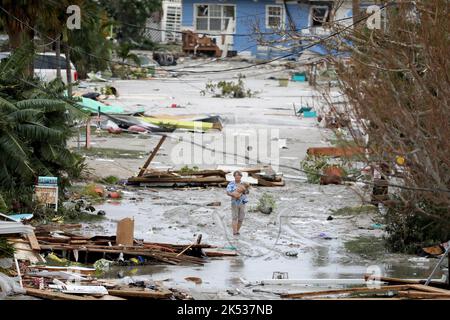 Fort Myers Beach, Stati Uniti. 29th Set, 2022. Pat Ton, che tiene il suo cane Ginger, prende i danni alle case e alle imprese sulla 3rd Street a Fort Myers Beach Giovedi, 29 settembre 2022, che è stato per lo più distrutto dopo l'uragano Ian fatto sbarco durante la notte di mercoledì. (Foto di Douglas R. Clifford/Tamps Bay Times/TNS/Sipa USA) Credit: Sipa USA/Alamy Live News Foto Stock