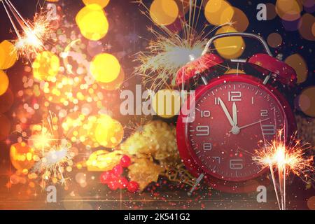 Collage festivo di sveglia, scintille natalizie e luci sfocate su sfondo scuro. Festa di Capodanno Foto Stock