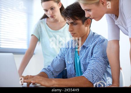 Lavorare insieme. Tre colleghi che lavorano in ufficio. Foto Stock