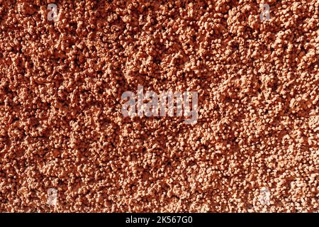 Struttura di cemento di argilla espansa. Intonaco rosso rosa rilievo, costituito da pietre di argilla espansa. Sfondo astratto. Foto Stock