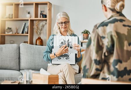 Salute mentale, terapia e inchiostro con una psicologa donna che mostra un quadro per un paziente durante una sessione di consulenza. Psicologia, medicina e salute Foto Stock