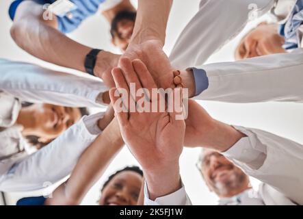 Mani, dottore e lavoro di squadra sotto in ospedale per motivazione, ispirazione e diversità sul lavoro. Medico, squadra e la mano insieme in collaborazione a. Foto Stock