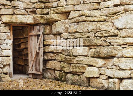 Aprire l'antica porta in legno in muratura ruvida Foto Stock
