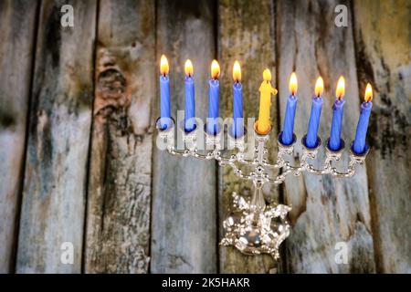 In questa festa di Hanukkah i simboli sono illuminati in menorah con le candele di festa ebraiche Foto Stock