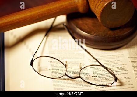 Che cosa è la legge realmente. Un dizionario aperto alla parola legge e un gavel e blocco. Foto Stock