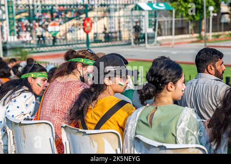 Persone pakistane che partecipano alla cerimonia di abbassamento della bandiera, Wagah confine, Pakistan Foto Stock