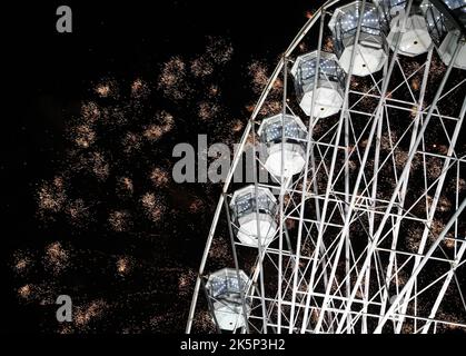 Leicester, Leicestershire, Regno Unito. 9th ottobre 2022. I fuochi d'artificio esplodono dietro la ruota della luce durante l'evento annuale di accensione delle luci Diwali sul Golden Mile. LeicesterÔs celebrazione di Diwali è una delle più grandi al di fuori dell'India. Credit Darren Staples/Alamy Live News. Foto Stock