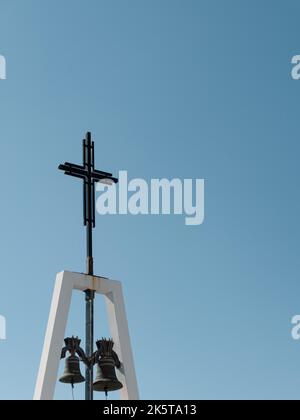 Croce religiosa e campane con un murale di pesca nella piccola città costiera di Tocha in Cantanhede, Portogallo. Foto: Notizie SMP Foto Stock