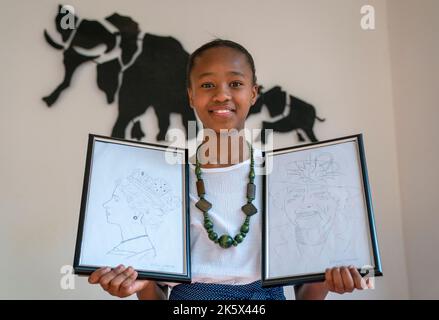 Afilwe Sebonego, di 11 anni, con disegni che ha creato della Regina Elisabetta II ad un ricevimento di Chevening and Commonwealth Scholars and Commonwealth Points of Light, presso la Westminster House, residenza dell'Alto Commissariato britannico, a Gaborone, celebrando i risultati accademici e comunitari di giovani provenienti da tutta la famiglia delle nazioni, Tra gli atleti che recentemente hanno partecipato ai Giochi del Commonwealth a Birmingham, mentre visita il Botswana. Data immagine: Lunedì 10 ottobre 2022. Foto Stock