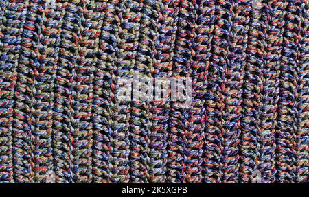 strisce colorate diverse sulla superficie del tessuto lavorato a maglia. tessuti tappeti retrò o tappeti. la texture del tessuto è una combinazione con la geometria di Foto Stock