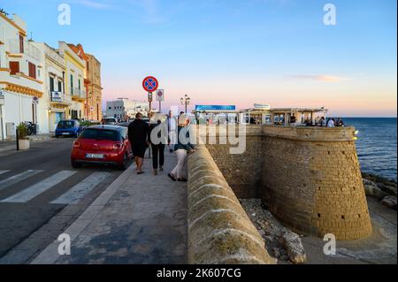 Le persone che si gustano cibo e bevande al ristorante all'aperto Buena Vista sul lungomare medievale bastione nel centro storico di Gallipoli, Puglia, Italia. Foto Stock