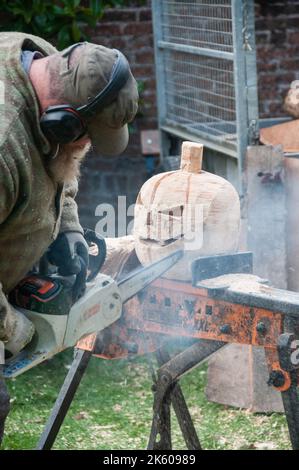 In tutto il Regno Unito - Chain Saw Carving - una zucca di legno per Halloween Foto Stock