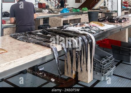 FUNCHAL, MADEIRA - 20 AGOSTO 2021: Si tratta di un pesce sciabola (espad) in vendita nel dipartimento del pesce del mercato agricolo. Foto Stock