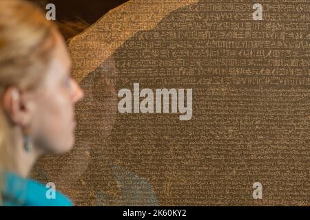 Londra, Regno Unito. Martedì, 11 ottobre, 2022. Geroglifici: Sbloccare l'antico Egitto, grande mostra al British Museum. Un membro dello staff, raffigurato con la pietra di Rosetta. Foto: Richard Gray/Alamy Live News Foto Stock