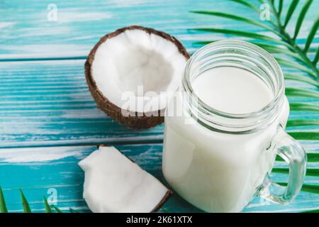Layout creativo composto da noci di cocco e foglie tropicali. Concetto di cibo Foto Stock