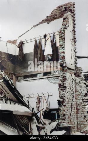 WW2 - "Dov'è George?" - Danni da bomba a Londra - Cappotti e cappelli lasciati sui ganci mentre il pavimento è scomparso. Foto Stock