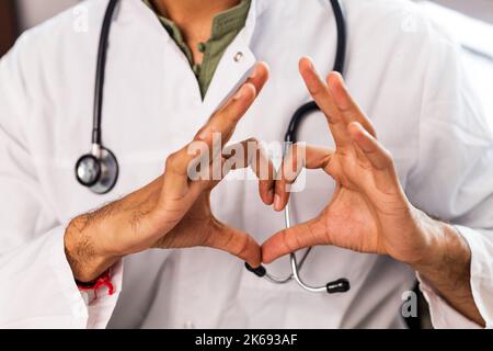 studente di medicina ispanica in camice bianco con stetoscopio in clinica Foto Stock