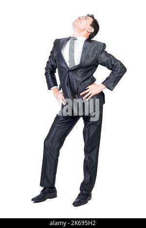 Un giovane uomo d'affari autoassicurato che guarda in uno studio bianco Foto Stock