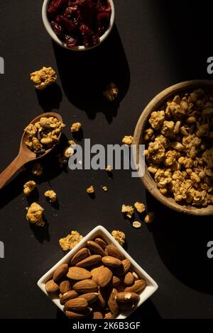 Granola fatta in casa con noci e semi. Snack salutare a colazione. Muesli fatti in casa di farina d'avena, uva passa, miele, mirtillo, lino, mandorle, macadamia, anacardi, appena sfornati Foto Stock