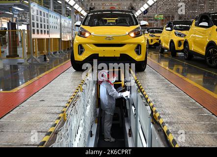 Wuhu, provincia cinese di Anhui. 12th Ott 2022. Un lavoratore è impegnato nella linea di produzione di veicoli a nuova energia (NEV) in una fabbrica di automobili cinesi Chery Holding Group Co., Ltd. A Wuhu City, provincia di Anhui, Cina orientale, 12 ottobre 2022. Da gennaio a luglio di quest'anno, la città di Wuhu ha prodotto 156.100 NEV, con un aumento del 130,2% su base annuale. Le vendite di NEV sono state pari a 137.900 unità, con un incremento del 36,8% su base annua. Credit: Zhou Mu/Xinhua/Alamy Live News Foto Stock