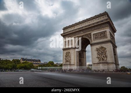 Arc de Triomphe al cielo drammatico con nuvole di tempesta e auto sfocata, Parigi, Francia Foto Stock