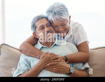 Mi sei mancato. una donna anziana che abbraccia il marito a casa. Foto Stock