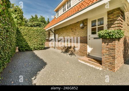 Piccolo e semplice patio con piccolo giardino vicino alla recinzione Foto Stock