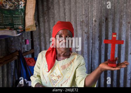 KENYA, Nairobi, Kibera slum, chiesa libera o chiesa pentecostale Santo Gesù, donna Katherine Kassoha con una croce rossa Foto Stock