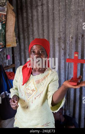 KENYA, Nairobi, Kibera slum, chiesa libera o chiesa pentecostale Santo Gesù, donna Katherine Kassoha con una croce rossa Foto Stock