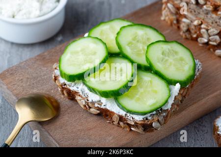 Fette di pane di segale con ricotta e cetrioli Foto Stock