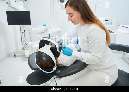 Lo stomatologo esamina i denti dei bambini utilizzando strumenti dentali Foto Stock