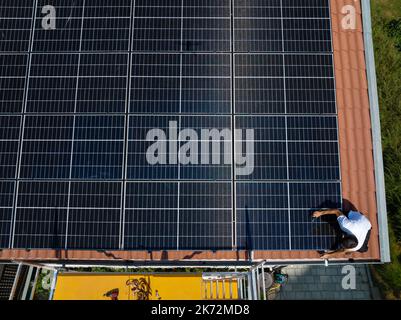 Installazione di pannelli solari sul tetto della casa Foto Stock
