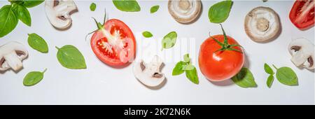 Funghi, pomodoro e basilico isolati su bianco. Motivo a superficie piana su sfondo bianco, vista dall'alto Foto Stock