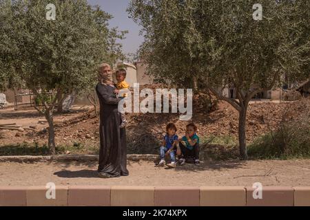 ©Chris Huby / le Pictorium/MAXPPP - Chris Huby / le Pictorium - 28/06/2017 - Syrie / Rojava / Raqa - Syrie - Rojava - Nord Syrien - 30 juin 2017. Ambiance de rue dans un petit village du nord syrien: Une femme tient son bebe. Chris Huby / le Pictorium - Siria: Campo profughi di Ain Issa - 28/06/2017 - Siria / Rojava / Raqqa - Siria - Rojava - Siria Nord - 30 giugno 2017. Atmosfera di strada in un piccolo villaggio nel nord della Siria: Una donna tiene il suo bambino. Foto Stock