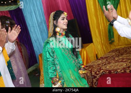 Tradizionale cerimonia Mayoon in un locale decorato con colori vivaci a Karachi, Pakistan Foto Stock