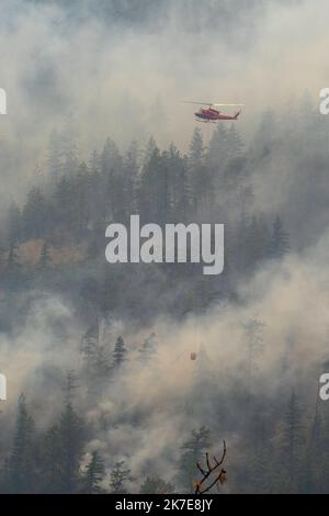 Un elicottero fa cadere l'acqua su un incendio boschivo che brucia al Nohomin Creek Fire nel Stein Valley NlakaÕpamux Heritage Provincial Park, a nord di Lytton, Foto Stock