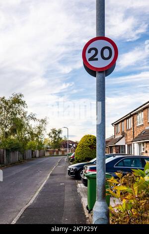 Vista dettagliata di un cartello del limite di velocità stradale UK 20MPH in una strada abbastanza suburbana. A causa della politica del governo gallese. Foto Stock